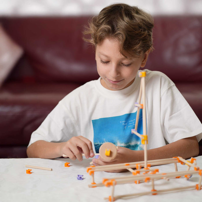 Mechanical model with white rods and colorful connectors on a white background from beaver