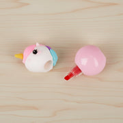 Unicorn-shaped bottle cap on a wooden surface