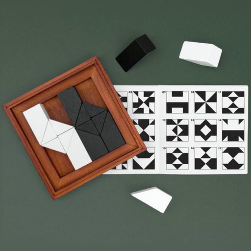 Wooden puzzle box with geometric shapes on a green background