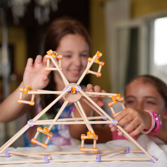 Mechanical model with white rods and colorful connectors on a white background from beaver