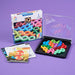 IQ Noodles game set with colorful links and packaging on a purple background