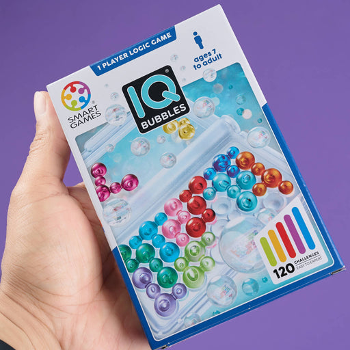 IQ Bubbles game box held by a hand with a purple background
