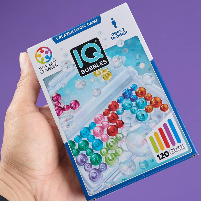 IQ Bubbles game box held by a hand with a purple background