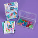 IQ Bubbles game set with packaging and colorful beads on a purple background