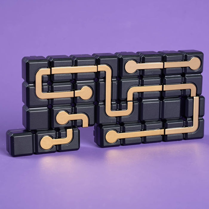 Black and gold puzzle toy on a purple background