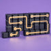 Black and gold puzzle toy on a purple background