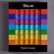 A boxed set of colorful translucent cube-shaped items labeled 'Plato's Cubes' on a black package, photographed against a plain gray background.