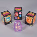 Three black retail boxes labeled 'Super Squeeze Glitter' and 'Capybara' arranged around a small glittery capybara figure in the foreground on a light gray studio background.