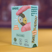 A light blue box of SPEKS. Mashable, smashable, buildable, grown-up fun.