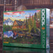 Eurographics puzzle Jigsaw puzzle box featuring a scenic cabin by a lake with mountains in the background.
