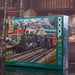 EUROGRAPHICS Jigsaw puzzle box featuring a train scene with mountains in the background