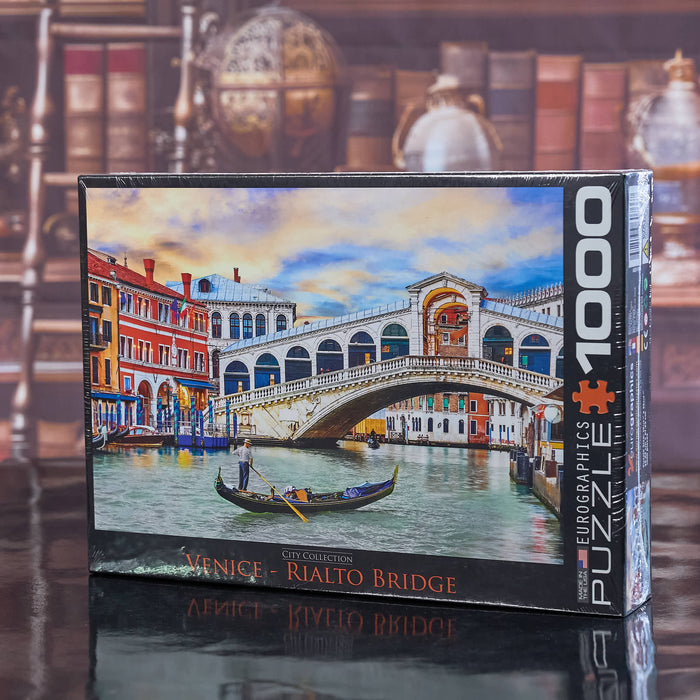 Jigsaw puzzle box featuring the Rialto Bridge in Venice with a cityscape background.