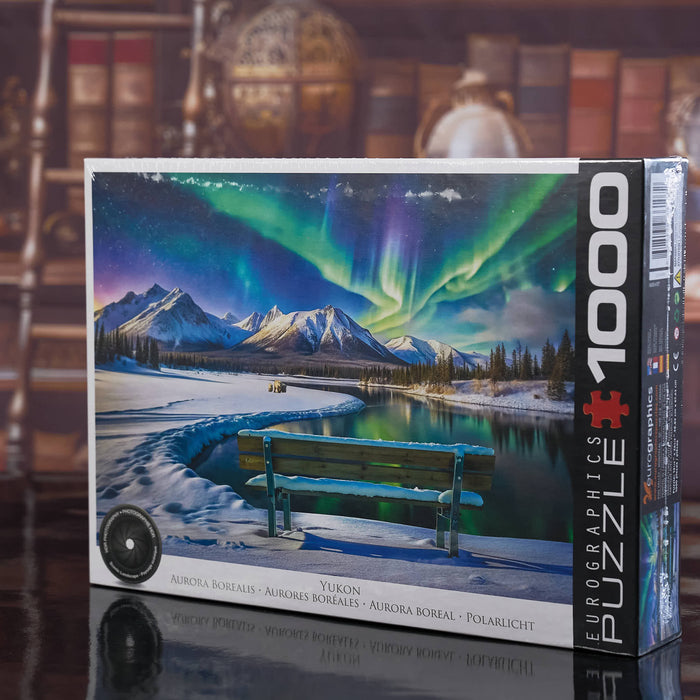 EUROGRAPHICS Jigsaw puzzle box featuring a scenic Aurora Borealis over mountains and lake with a bench.