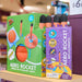 A retail display of Pop Rocket Aero Rocket toy set, showing the green original box, a purple box of foam rocket replacements, and several orange foam rockets with black tips on a store shelf.