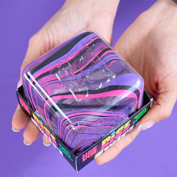 A pair of hands holding a clear plastic box containing multiple translucent silicone wristbands with purple, pink, and black marbled stripes, set against a solid purple background.