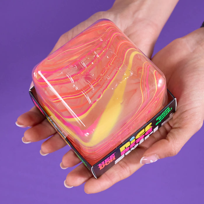 A person's hands holding a square plastic container filled with a marbled, translucent pink, orange, and yellow substance against a solid purple background, 'Nice Berg Swirl'