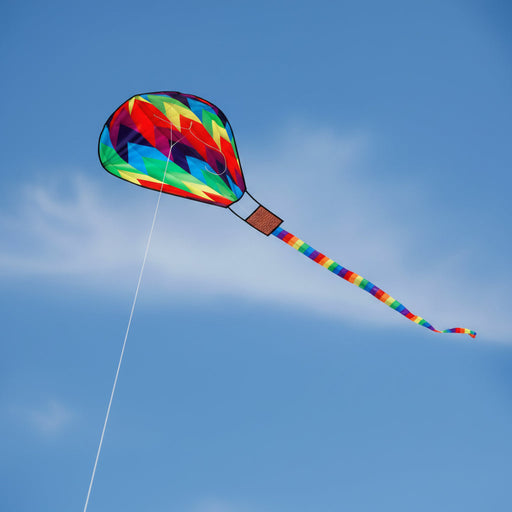 Colorful kite flying against a clear blue sky