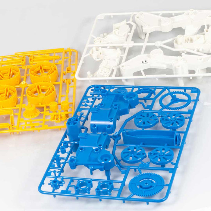 Set of plastic toy parts including gears and mechanical components on a white background