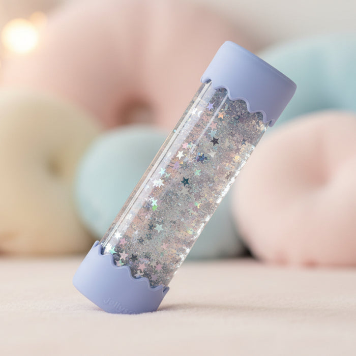 Glittery calm bottle with blue cap on a soft surface