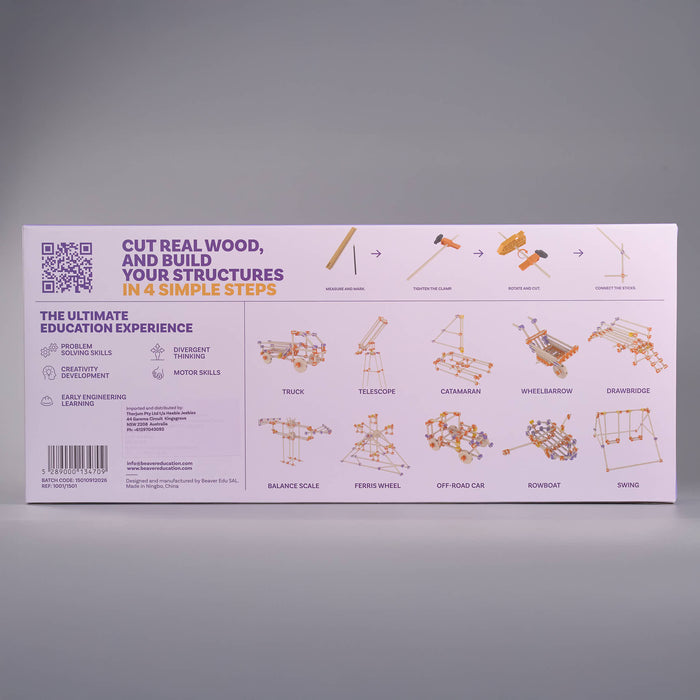The product packaging box for an educational wood model kit, displayed against a neutral gray background. The box is light pink with purple and orange text and diagrams showing how to build structures like a track, telescope, and car.
