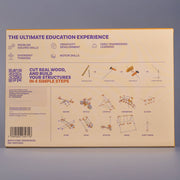 An educational poster or booklet cover titled 'THE ULTIMATE EDUCATION EXPERIENCE' with text about problem solving, creativity, and motor skills, plus small diagrams and labeled structures such as bicycle, catapult, dambridge, and glass. The page is photographed against a plain gray background.