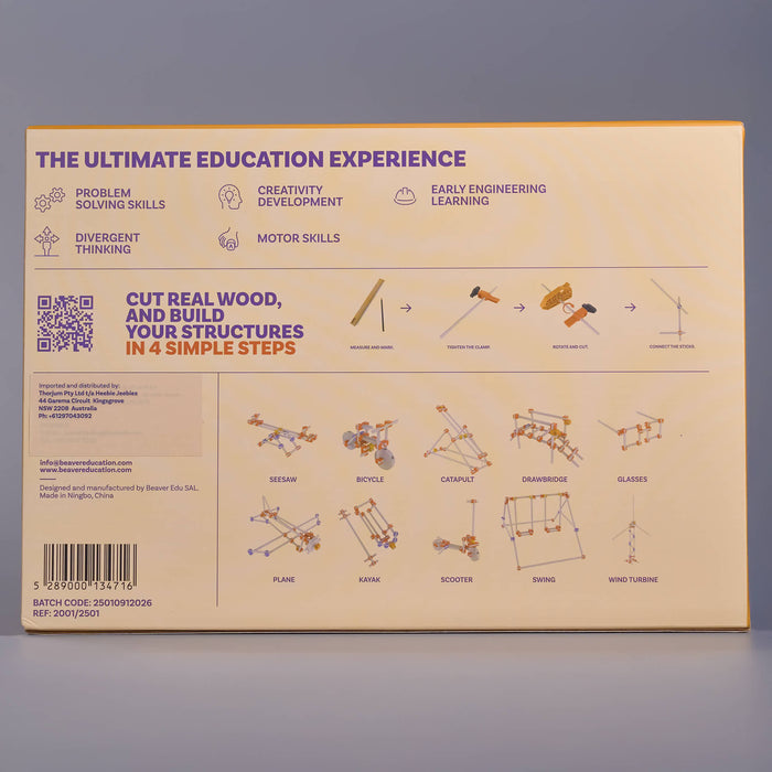 An educational poster or booklet cover titled 'THE ULTIMATE EDUCATION EXPERIENCE' with text about problem solving, creativity, and motor skills, plus small diagrams and labeled structures such as bicycle, catapult, dambridge, and glass. The page is photographed against a plain gray background.