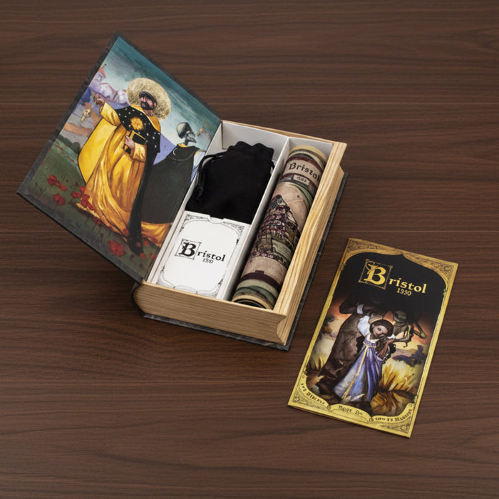 Wooden box with a rolled-up fabric and two cards on a wooden surface, featuring the brand 'Bristol'.