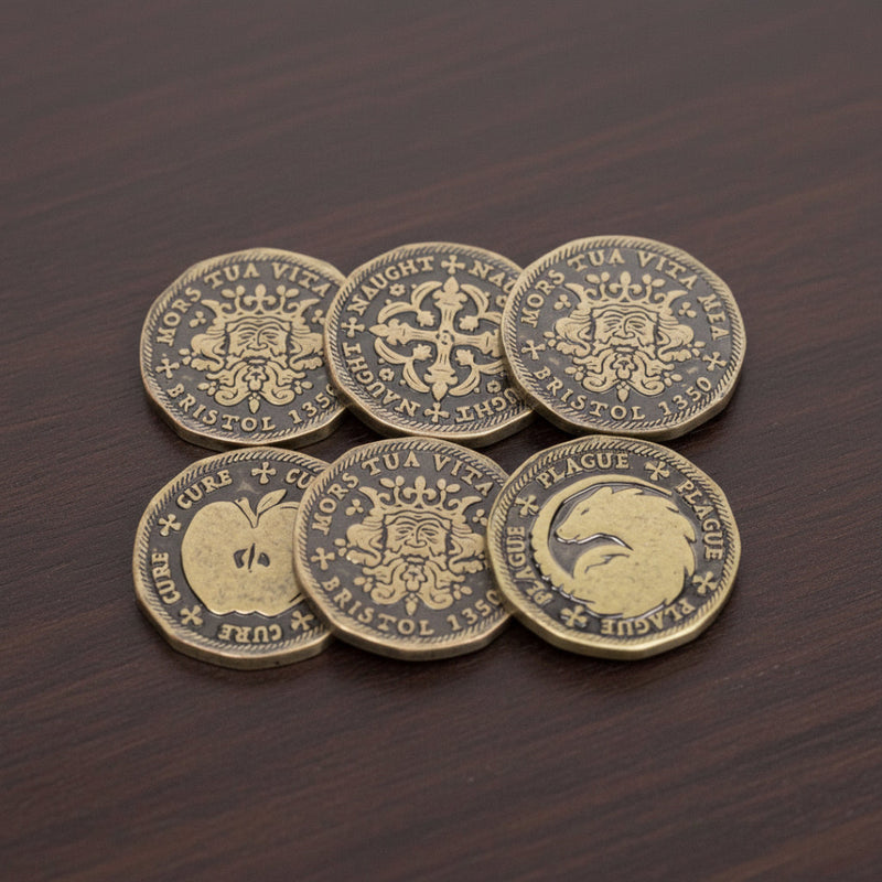 Set of six decorative coins with intricate designs on a wooden surface