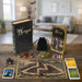 Game Bristol 1350 components including a book, cards, and miniatures on a wooden surface with a rustic background.