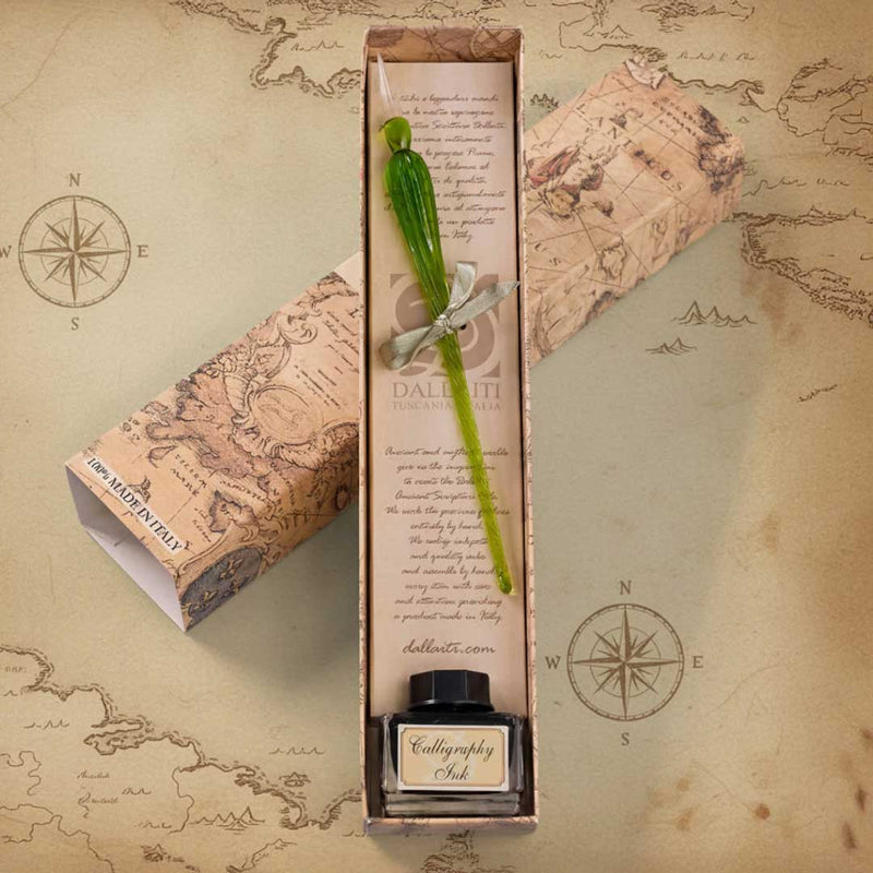 Calligraphy set with green pen and ink bottle on an old map background