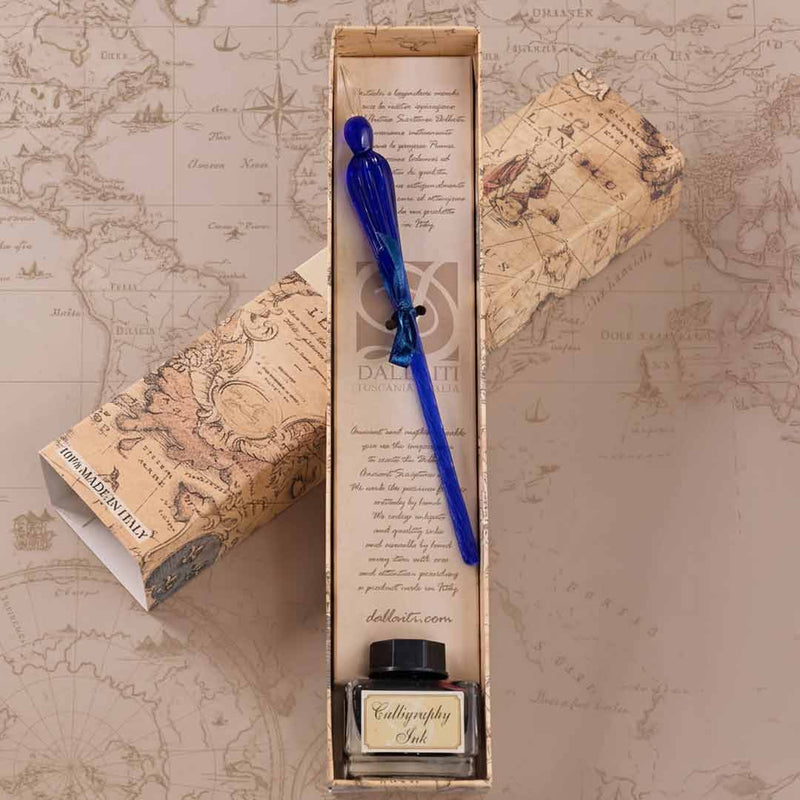 Calligraphy set with blue pen and ink bottle in a decorative box on a map background