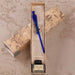 Calligraphy set with blue pen and ink bottle in a decorative box on a map background