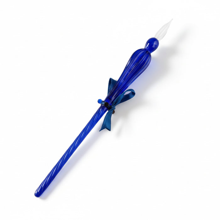 Blue glass candle snuffer with a bow on a gray background