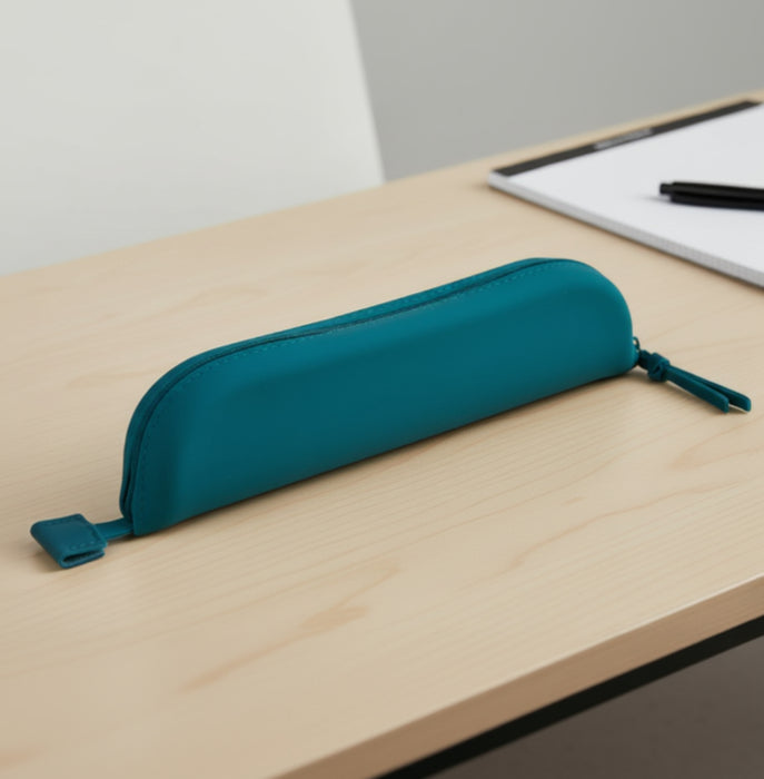 Teal pencil case on a wooden desk with a whiteboard in the background