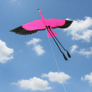 Pink flamingo kite with black wings on a blue sky background