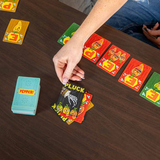Card game in progress with colorful cards on a wooden table