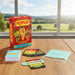 Board game 'Pepper!' with cards and pieces on a wooden table with a scenic background