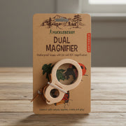 Huckleberry dual magnifier on a brown packaging with nature-themed illustrations.