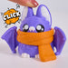 a click 3D-printed cute ghost figurine wearing an orange knit beanie with a white pom-pom and an orange scarf, set against a plain light gray background.