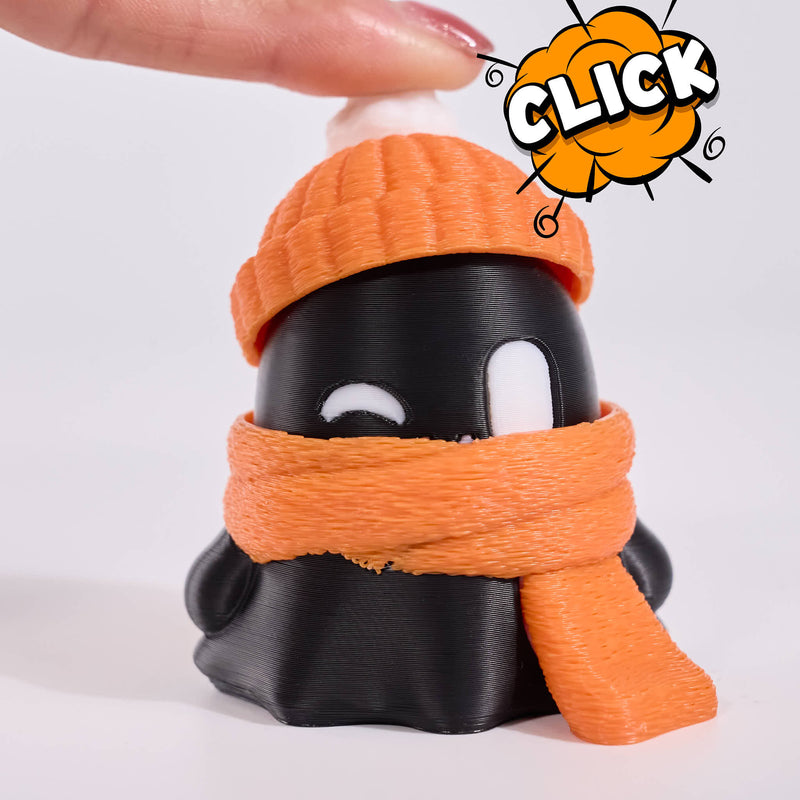 click A 3D-printed cute ghost figurine wearing an orange knit beanie with a white pom-pom and an orange scarf, set against a plain light gray background.