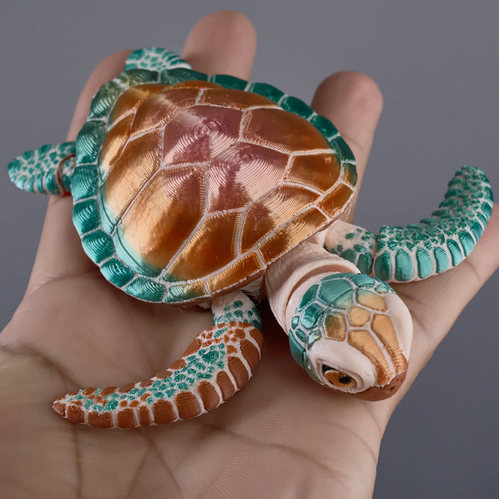 Toy turtle held in a hand against a neutral background