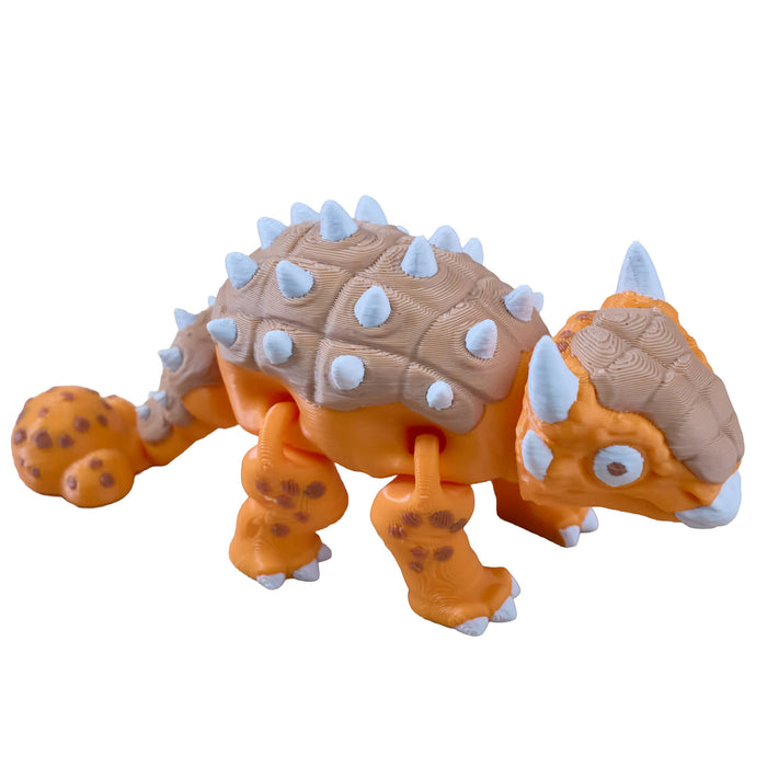 Toy dinosaur figure with orange body, brown back, and white spikes on a white background