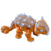 Toy dinosaur figure with orange body, brown back, and white spikes on a white background