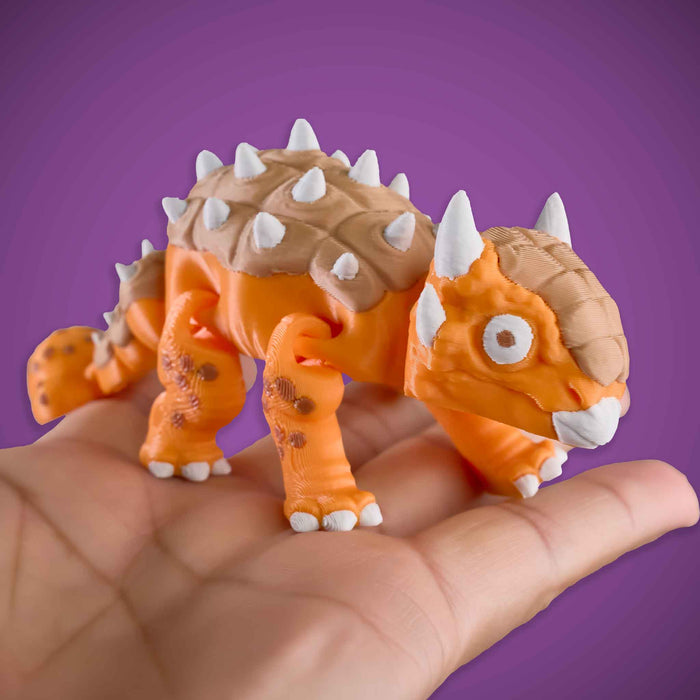 Toy dinosaur figure held in a hand against a purple background