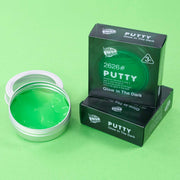 Green glow-in-the-dark putty with packaging on a green background