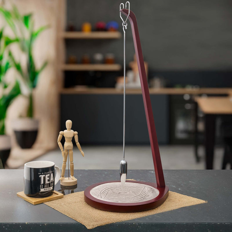Modern Foucault Pendulum decorative items in a home office.