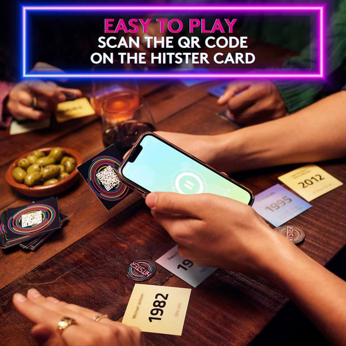 People playing a card game with a smartphone scanning a QR code on a card, set against a bar or casual gathering backdrop.