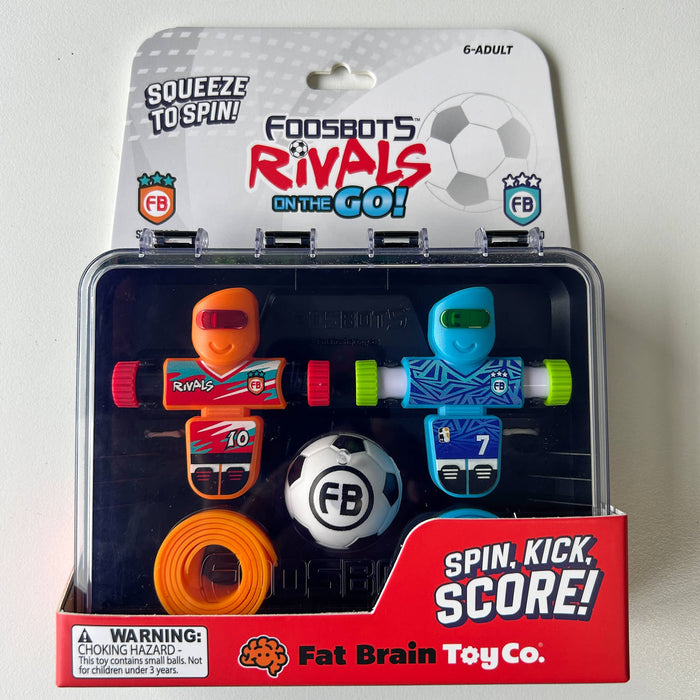 Packaged toy set with two characters and a ball, featuring Fat Brain Toy Co branding.