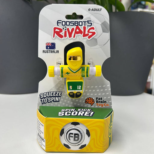 AUSTRALIA Foosbots Rivals toy packaging with a yellow and green toy figure on a white surface.