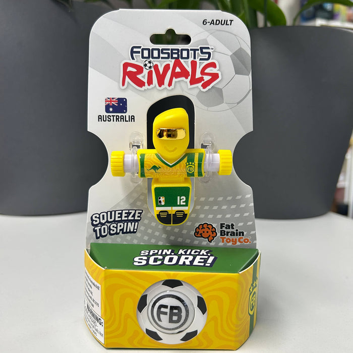 AUSTRALIA Foosbots Rivals toy packaging with a yellow and green toy figure on a white surface.